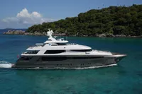 Luxurious 2016 Crescent Full Displacement yacht cruising near lush green island.