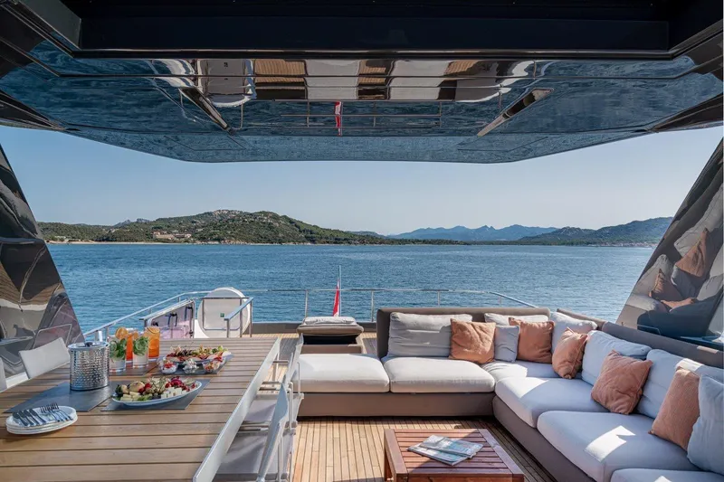  Yacht Photos Pics Luxurious 2018 Ferretti Yachts 850 deck with elegant seating and scenic ocean view.