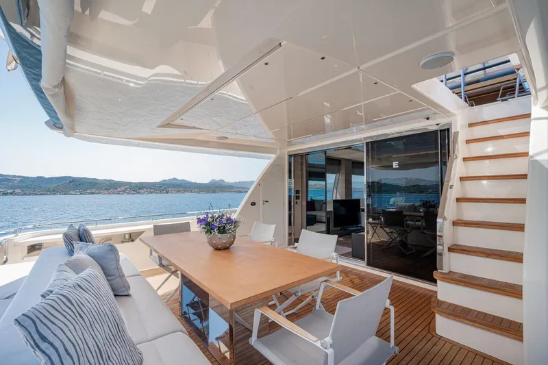  Yacht Photos Pics Luxurious 2018 Ferretti Yachts 850 deck with elegant seating and scenic ocean view.