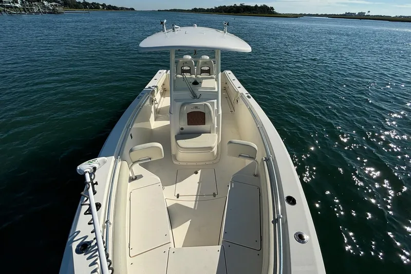  Yacht Photos Pics 2020 Cobia 280 Center Console boat on calm water, showcasing spacious deck and seating.