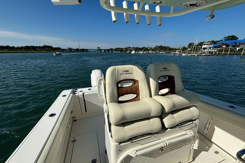  Yacht Photos Pics 2020 Cobia 280 Center Console boat on water, featuring comfortable seating and scenic view.