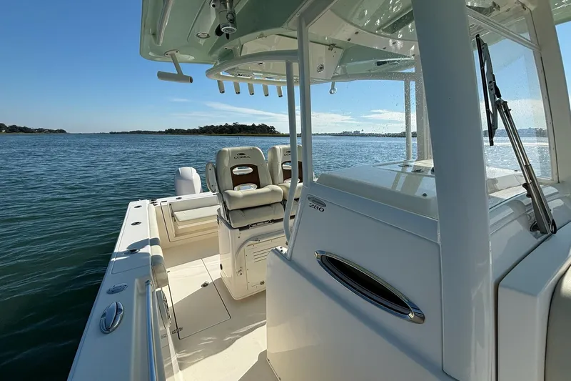  Yacht Photos Pics 2020 Cobia 280 Center Console boat on calm waters, showcasing sleek design and spacious deck.