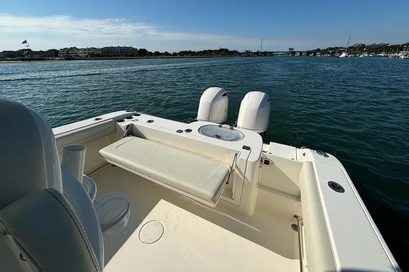  Yacht Photos Pics 2020 Cobia 280 Center Console boat on calm water, featuring dual engines and seating.