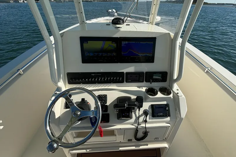  Yacht Photos Pics 2020 Cobia 280 Center Console boat dashboard with steering wheel and navigation screens.