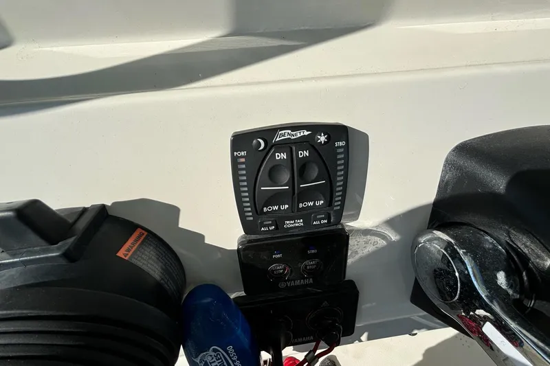  Yacht Photos Pics Control panel of a 2020 Cobia 280 Center Console boat with trim tab controls.