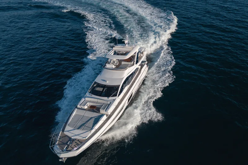  Yacht Photos Pics 2023 Azimut 72 Flybridge yacht cruising on open water, aerial view.