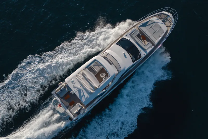  Yacht Photos Pics Aerial view of 2023 Azimut 72 Flybridge yacht cruising on the ocean.