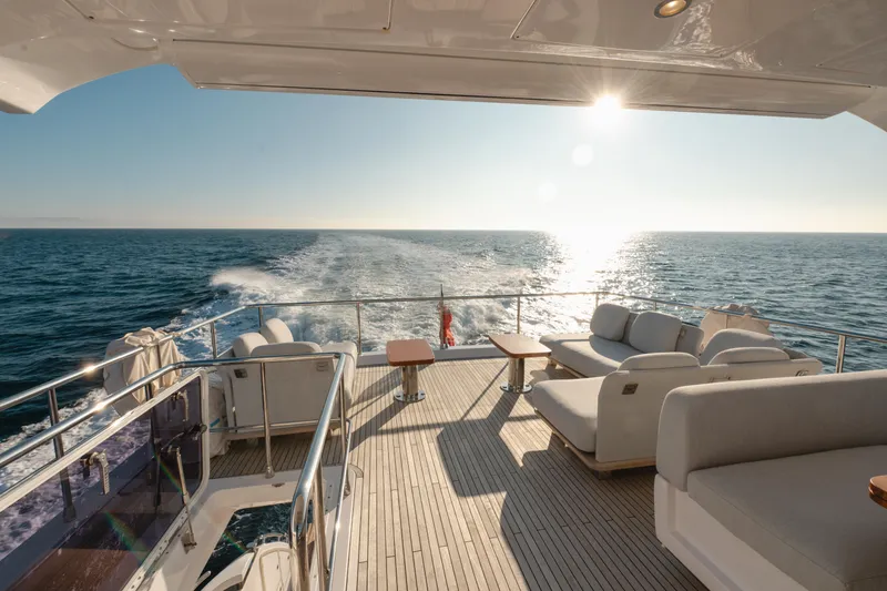  Yacht Photos Pics Luxurious 2023 Azimut 72 Flybridge yacht cruising on open sea at sunset.