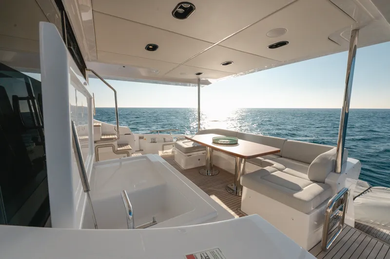  Yacht Photos Pics Luxurious 2023 Azimut 72 Flybridge yacht with elegant outdoor seating and ocean view.