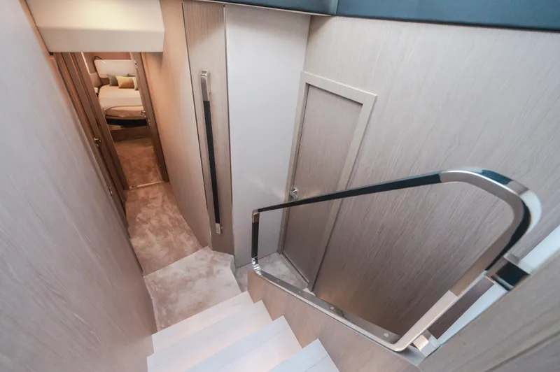  Yacht Photos Pics Interior staircase of 2023 Azimut 72 Flybridge yacht, leading to luxurious cabin area.