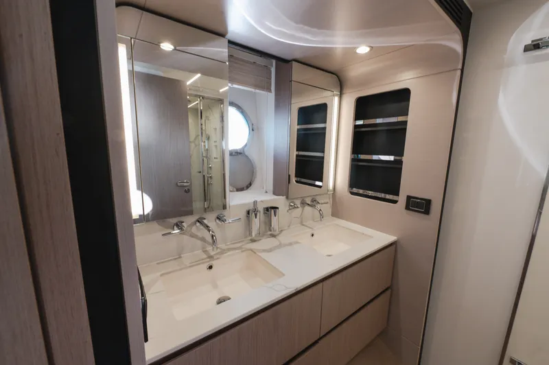  Yacht Photos Pics Luxurious bathroom interior of 2023 Azimut 72 Flybridge yacht with dual sinks and modern fixtures.