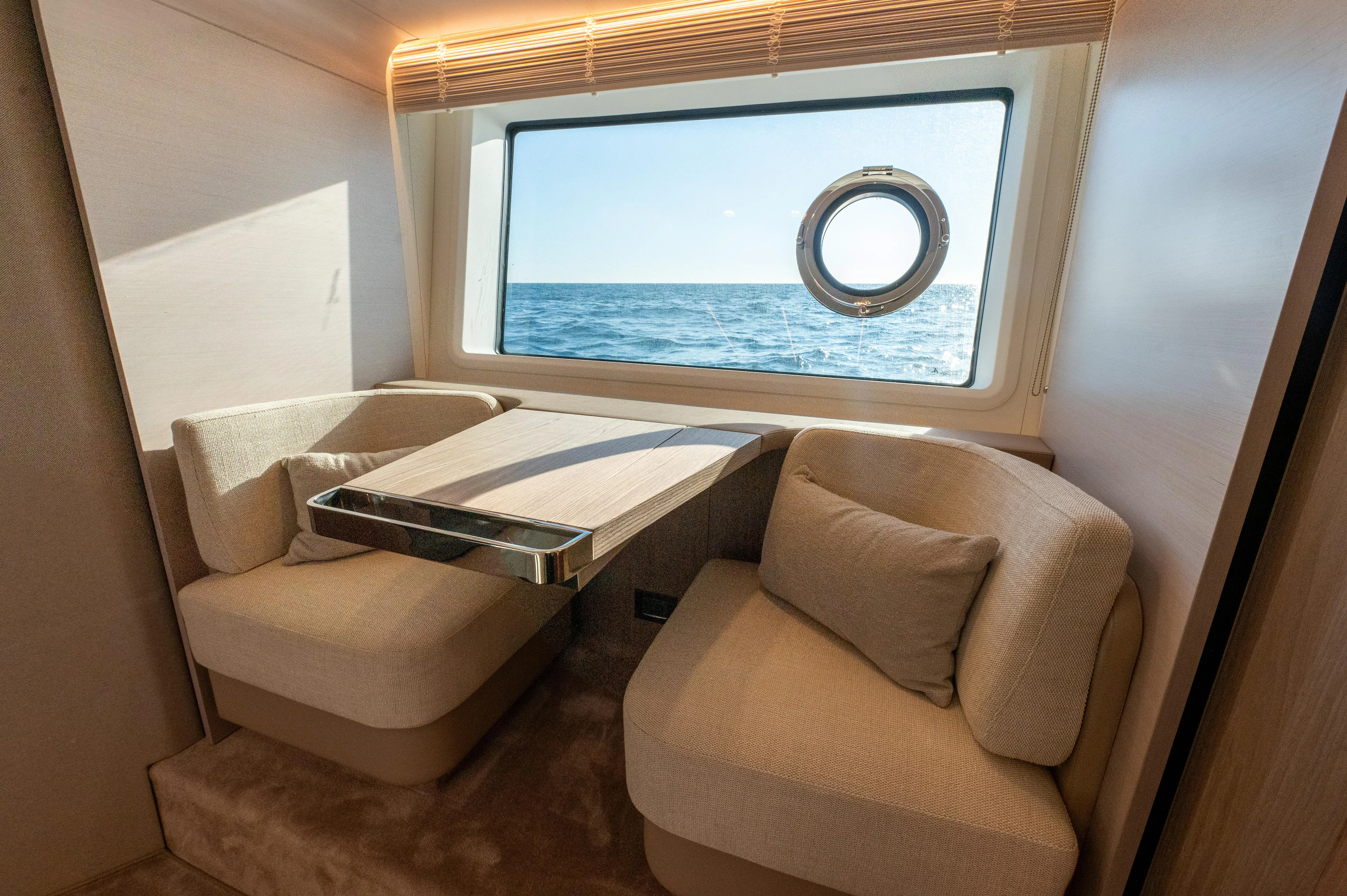  Yacht Photos Pics Luxurious interior of 2023 Azimut 72 Flybridge yacht with ocean view through window.