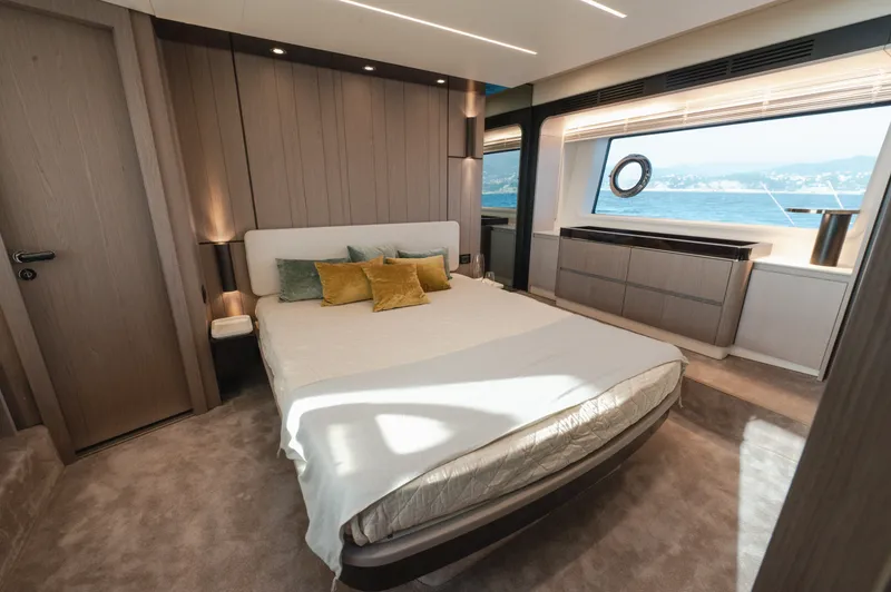  Yacht Photos Pics Luxurious bedroom interior of 2023 Azimut 72 Flybridge yacht with ocean view.