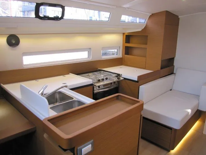  Yacht Photos Pics 2024 Jeanneau Sun Odyssey 410 interior with modern kitchen and seating area.