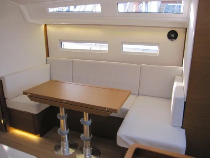  Yacht Photos Pics Interior of 2024 Jeanneau Sun Odyssey 410 yacht with modern seating and table.