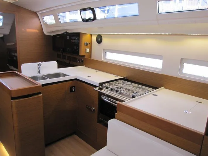  Yacht Photos Pics 2024 Jeanneau Sun Odyssey 410 interior kitchen with modern appliances and sleek design.