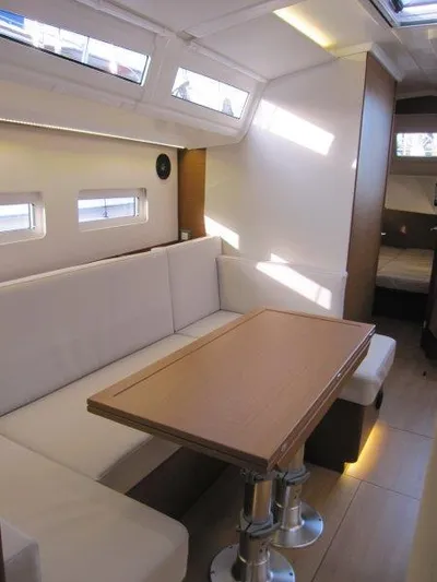  Yacht Photos Pics 2024 Jeanneau Sun Odyssey 410 interior with modern seating and dining area.