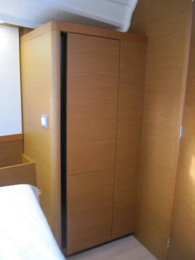  Yacht Photos Pics 2024 Jeanneau Sun Odyssey 410 interior with wooden cabinetry.