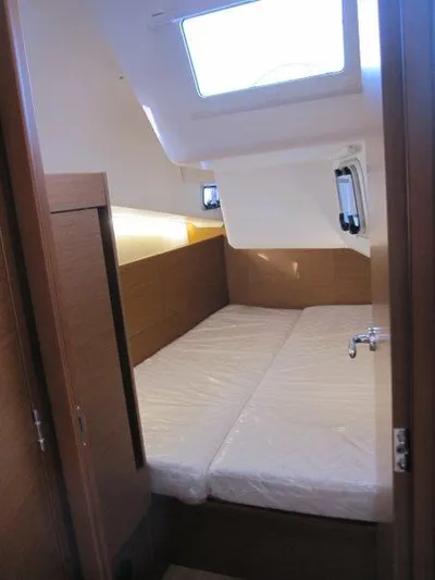  Yacht Photos Pics 2024 Jeanneau Sun Odyssey 410 cabin interior with twin beds and natural lighting.