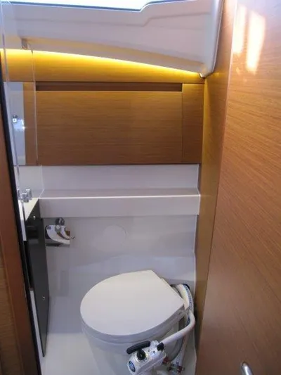  Yacht Photos Pics 2024 Jeanneau Sun Odyssey 410 yacht bathroom with modern fixtures and wood accents.