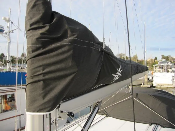  Yacht Photos Pics 2024 Jeanneau Sun Odyssey 410 sailboat with covered mainsail in marina.