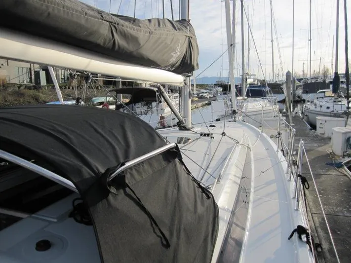  Yacht Photos Pics 2024 Jeanneau Sun Odyssey 410 sailboat docked in a marina, showcasing sleek design and rigging.
