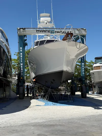  Yacht Photos Pics Buddy Davis 78 yacht from 2000 in a marina lift, ready for maintenance.