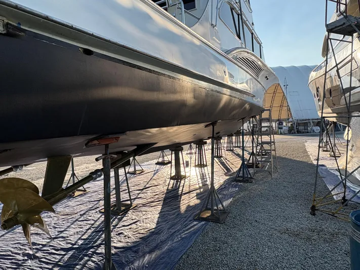 Yacht Photos Pics Buddy Davis 78 yacht from 2000 on stands in a boatyard, side view.