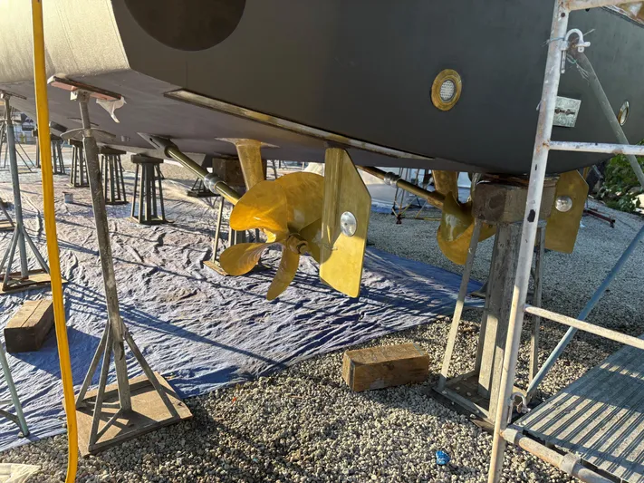  Yacht Photos Pics Propellers of a 2000 Buddy Davis 78 yacht on dry dock, supported by stands.