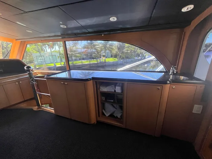  Yacht Photos Pics Interior of 2000 Buddy Davis 78 yacht with wooden cabinetry and large windows.