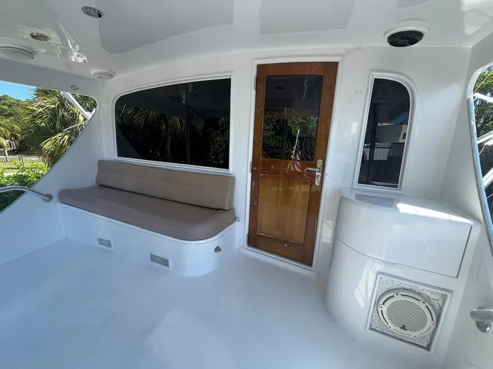  Yacht Photos Pics Interior view of 2000 Buddy Davis 78 yacht with seating and wooden door.