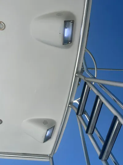  Yacht Photos Pics View of Buddy Davis 78 yacht's deck lights and ladder against clear blue sky.