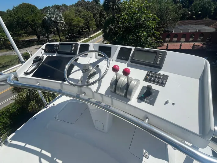  Yacht Photos Pics Control panel of a 2000 Buddy Davis 78 yacht with steering wheel and navigation equipment.