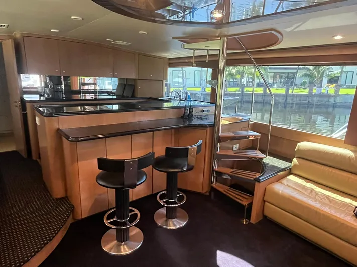  Yacht Photos Pics Luxurious interior of 2000 Buddy Davis 78 yacht with modern kitchen and spiral staircase.