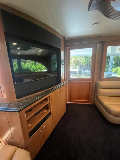  Yacht Photos Pics Interior of 2000 Buddy Davis 78 yacht with modern wood cabinetry and large TV.