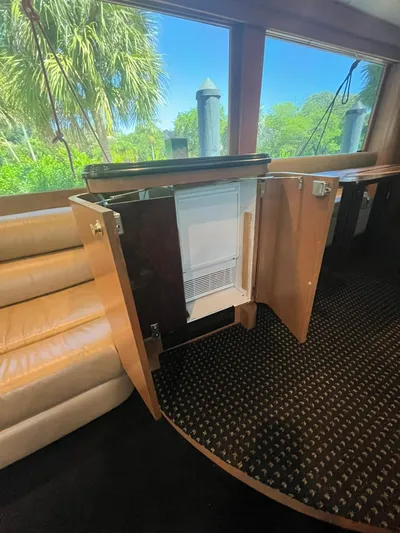  Yacht Photos Pics Interior of 2000 Buddy Davis 78 yacht with open mini fridge and scenic window view.