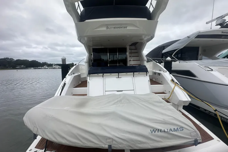  Yacht Photos Pics 2018 Sunseeker Manhattan 52 yacht docked, rear view with covered tender.
