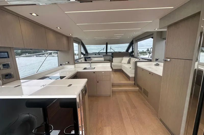  Yacht Photos Pics Luxurious interior of 2018 Sunseeker Manhattan 52 yacht with modern kitchen and seating area.
