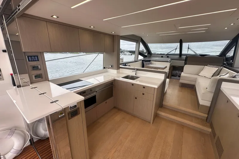  Yacht Photos Pics Luxurious interior of 2018 Sunseeker Manhattan 52 yacht with modern kitchen and seating area.