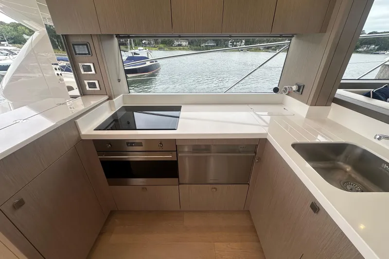  Yacht Photos Pics Modern kitchen interior of 2018 Sunseeker Manhattan 52 yacht with sleek appliances and waterfront view.