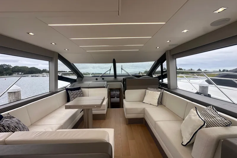  Yacht Photos Pics Luxurious interior of 2018 Sunseeker Manhattan 52 yacht with elegant seating and panoramic windows.