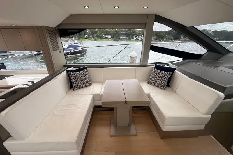  Yacht Photos Pics Luxurious interior of 2018 Sunseeker Manhattan 52 yacht with elegant seating and scenic view.