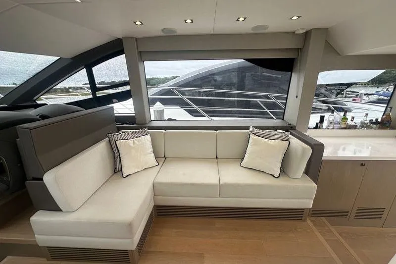  Yacht Photos Pics Luxurious interior of 2018 Sunseeker Manhattan 52 yacht with elegant seating and large windows.