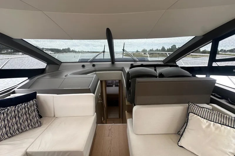  Yacht Photos Pics Interior view of 2018 Sunseeker Manhattan 52 yacht, featuring elegant seating and panoramic windows.