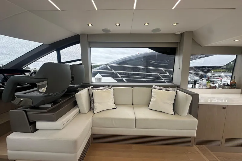  Yacht Photos Pics Luxurious interior of 2018 Sunseeker Manhattan 52 yacht with modern seating and large windows.