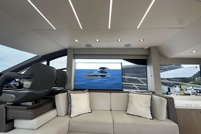  Yacht Photos Pics Luxurious interior of 2018 Sunseeker Manhattan 52 yacht with modern seating and large windows.
