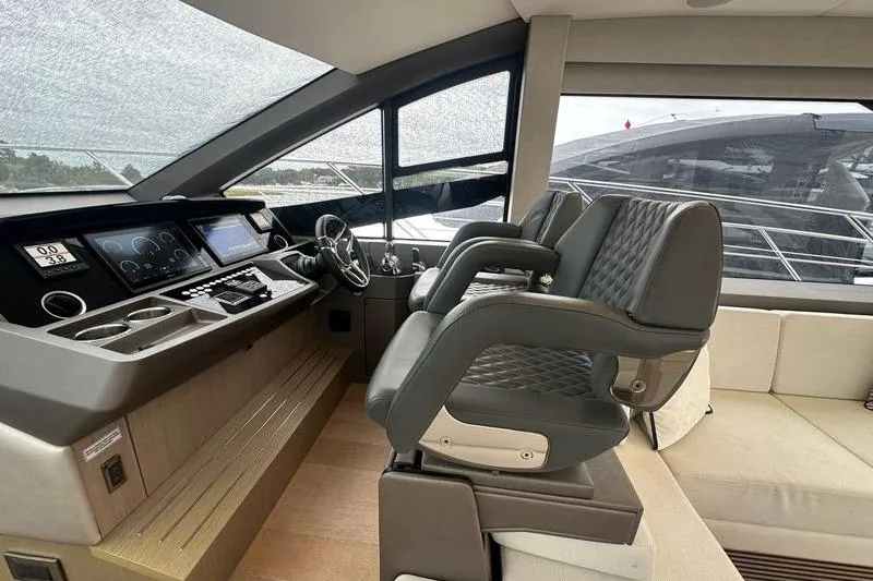  Yacht Photos Pics Interior helm of 2018 Sunseeker Manhattan 52 yacht with modern controls and seating.
