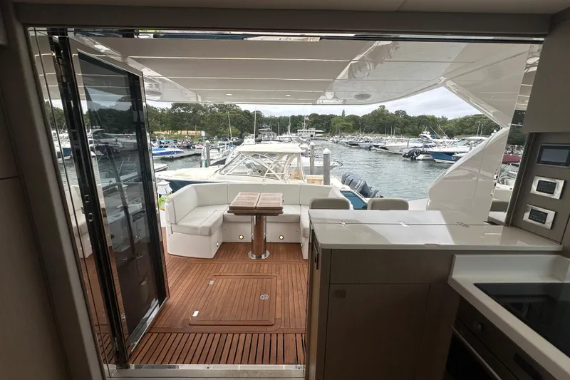  Yacht Photos Pics Luxurious 2018 Sunseeker Manhattan 52 yacht interior with elegant wood flooring and marina view.