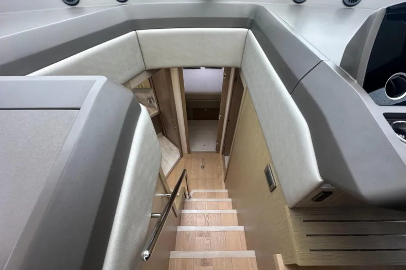  Yacht Photos Pics Interior view of 2018 Sunseeker Manhattan 52 yacht, featuring modern staircase and sleek design.
