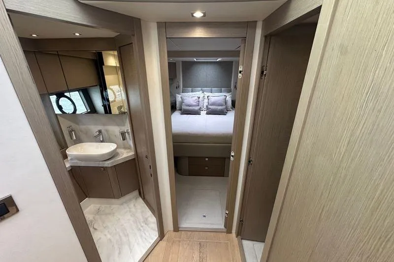  Yacht Photos Pics Luxurious interior of 2018 Sunseeker Manhattan 52 yacht, featuring bedroom and bathroom.